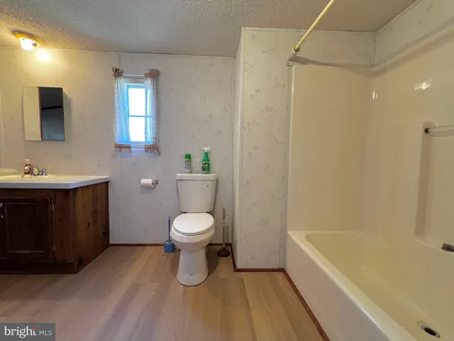 a bathroom with a toilet a sink and bathtub
