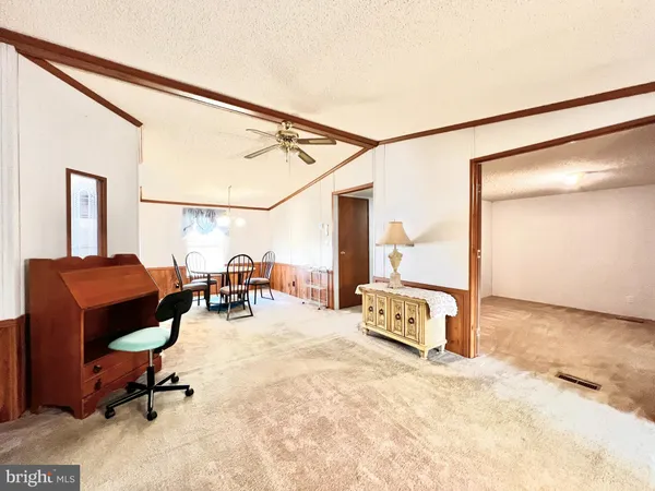 a view of a livingroom with furniture and a workspace