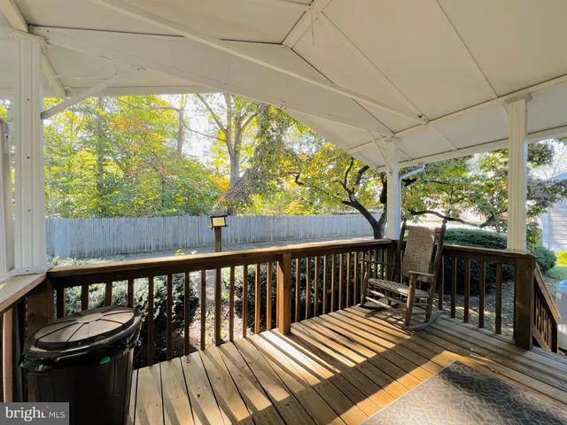 a view of balcony with wooden floor and outdoor seating