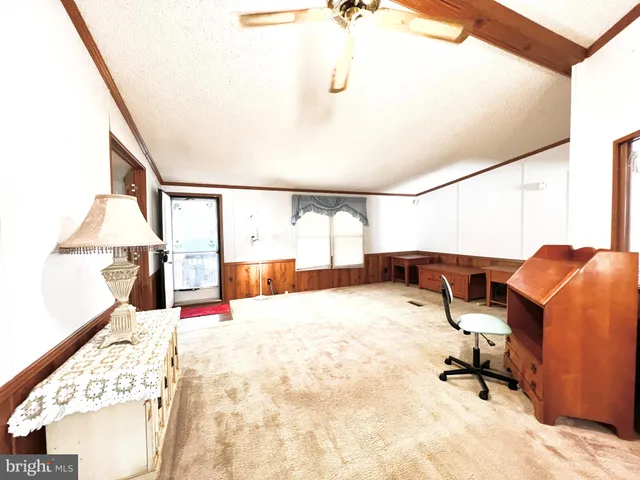 a living room with furniture window and white walls