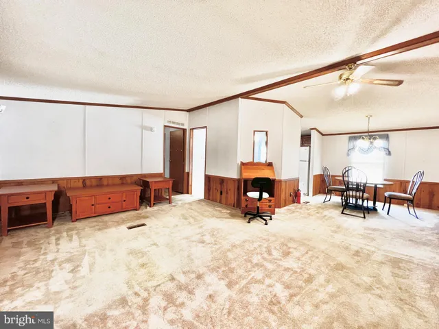 a view of a bedroom with furniture and a flat screen tv