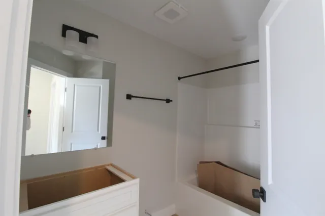 a bathroom with a tub and shower