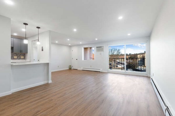 64 Main Street, Unit 53B Stoneham, MA 02180 - Photo 12 of 36 a view of a big room with wooden floor and windows