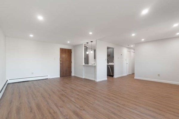 64 Main Street, Unit 53B Stoneham, MA 02180 - Photo 14 of 36 a view of an empty room with wooden floor and a window