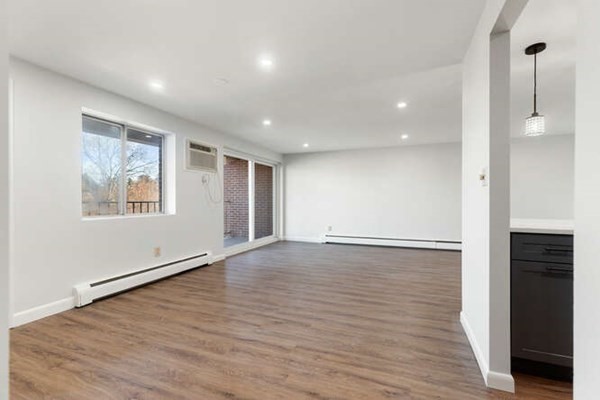 64 Main Street, Unit 53B Stoneham, MA 02180 - Photo 16 of 36 a view of an empty room with wooden floor and a window
