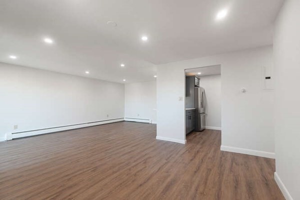 64 Main Street, Unit 53B Stoneham, MA 02180 - Photo 17 of 36 a view of an empty room with wooden floor