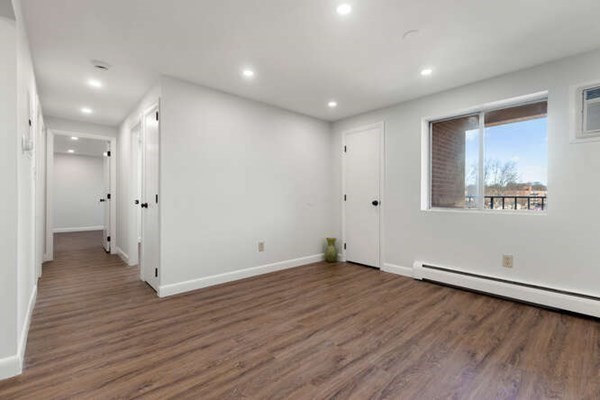 64 Main Street, Unit 53B Stoneham, MA 02180 - Photo 18 of 36 an empty room with wooden floor and windows