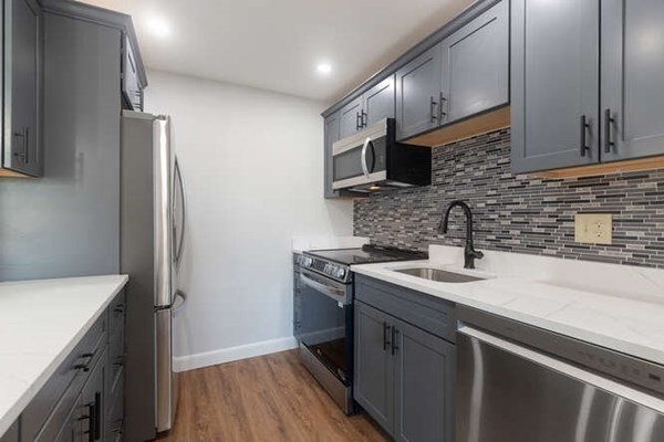 64 Main Street, Unit 53B Stoneham, MA 02180 - Photo 22 of 36 a kitchen with stainless steel appliances granite countertop a sink stove and refrigerator