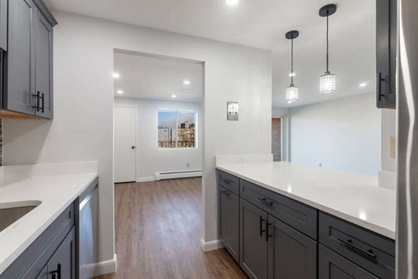 64 Main Street, Unit 53B Stoneham, MA 02180 - Photo 23 of 36 a view of a kitchen with a sink and wooden floor
