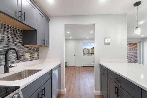 64 Main Street, Unit 53B Stoneham, MA 02180 - Photo 24 of 36 a kitchen with a sink cabinets a counter top space and stainless steel appliances