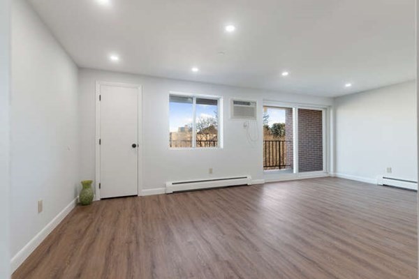 64 Main Street, Unit 53B Stoneham, MA 02180 - Photo 25 of 36 an empty room with wooden floor and windows