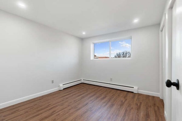 64 Main Street, Unit 53B Stoneham, MA 02180 - Photo 26 of 36 an empty room with wooden floor and windows