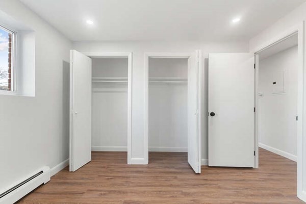 64 Main Street, Unit 53B Stoneham, MA 02180 - Photo 27 of 36 a view of an empty room with wooden floor