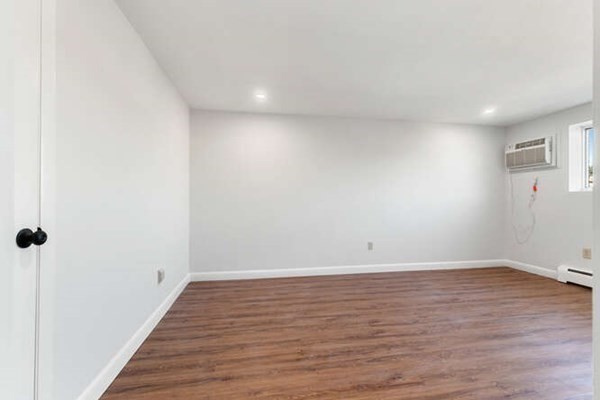 64 Main Street, Unit 53B Stoneham, MA 02180 - Photo 28 of 36 a view of an empty room with wooden floor and a window