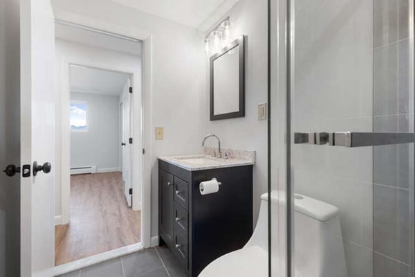 64 Main Street, Unit 53B Stoneham, MA 02180 - Photo 34 of 36 a bathroom with a sink and a mirror