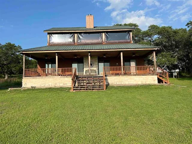 a view of a backyard with a garden and entertaining space