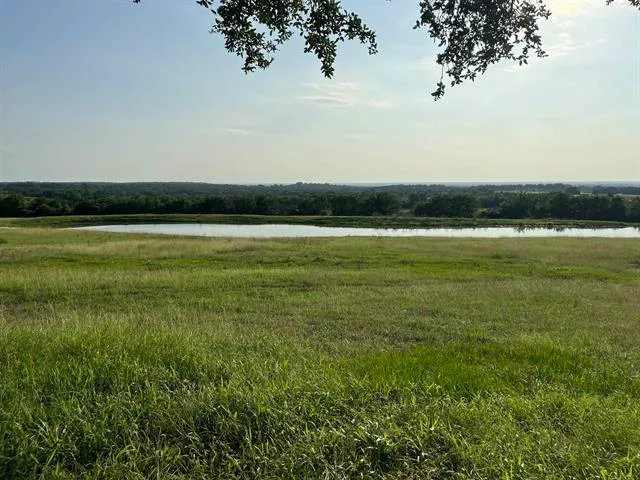 a living room with a fireplace and wooden floor