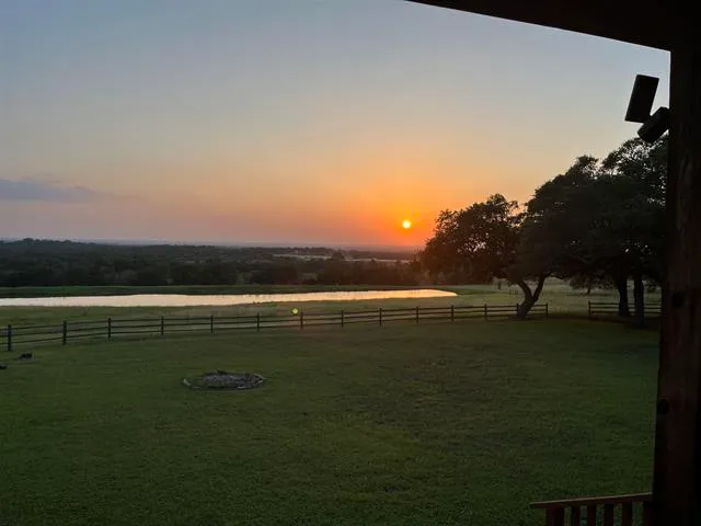 a view of a swimming pool with a house in the background