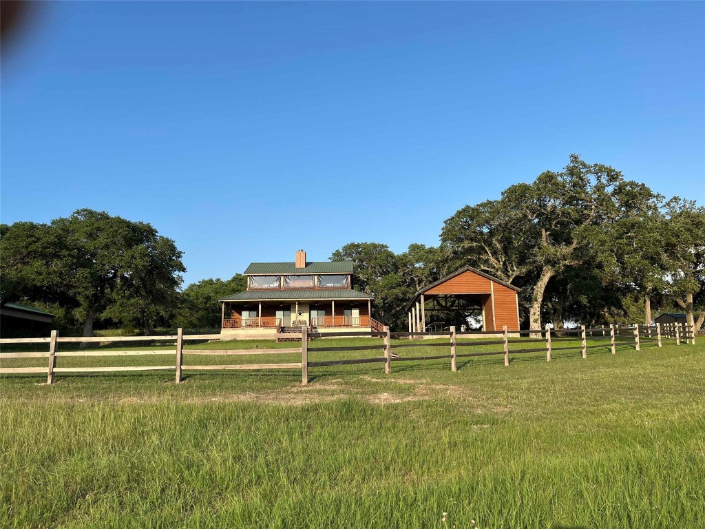 534 Scott's School Road Flatonia, TX 78941 - Photo 18 of 27 a view of a swimming pool with a house in the background