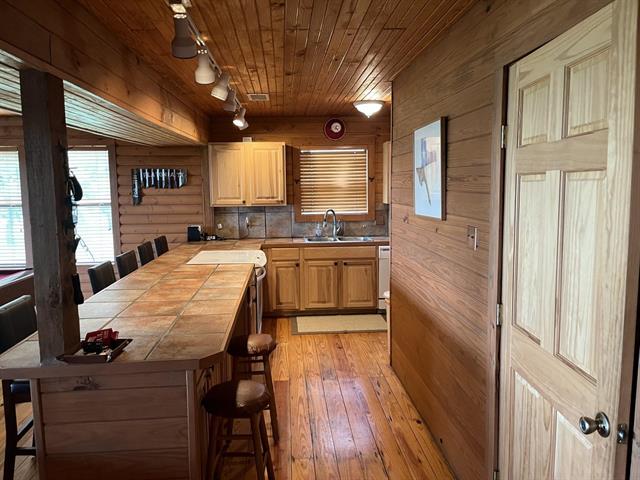 534 Scott's School Road Flatonia, TX 78941 - Photo 4 of 27 a large kitchen with kitchen island a large counter space a sink a window and stainless steel appliances