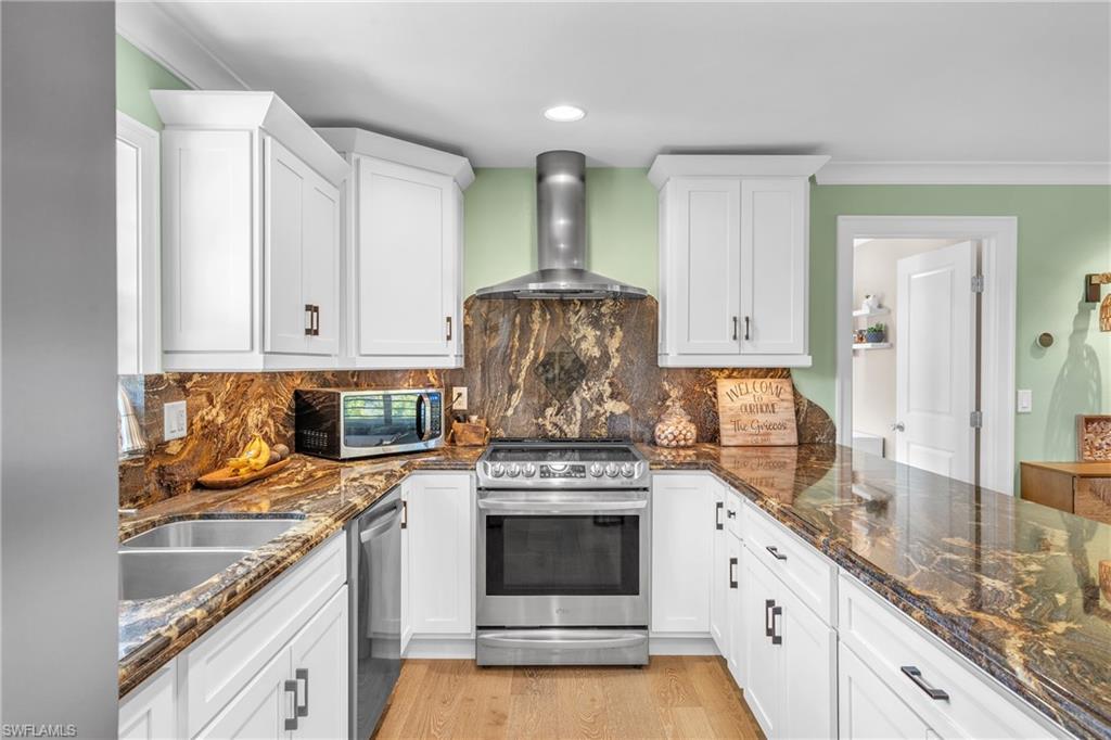3001 50th Street Southwest Naples, FL 34116 - Photo 5 of 46 a kitchen with stainless steel appliances granite countertop a stove and a sink