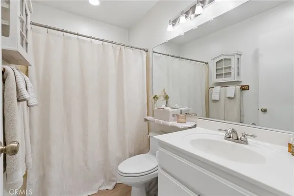 a bathroom with a toilet a sink and a mirror