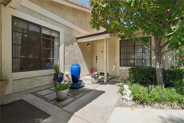 a group of people sitting in front of a house