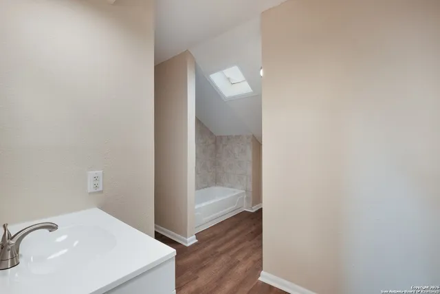 a bathroom with a sink and shower