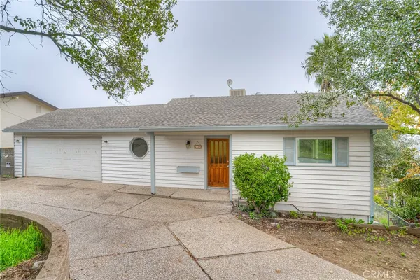a house that has a tree in front of the house