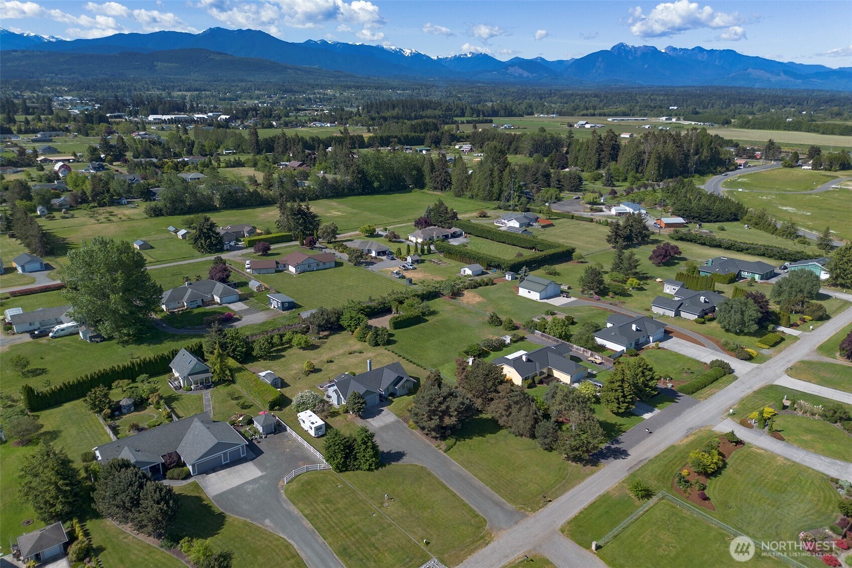 101 Timothy Lane Sequim, WA 98382 - Photo 35 of 39 an aerial view of green landscape with trees houses and mountain view