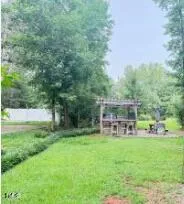 a view of a house with a back yard