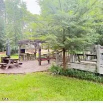 a view of yard with swimming pool and sitting area