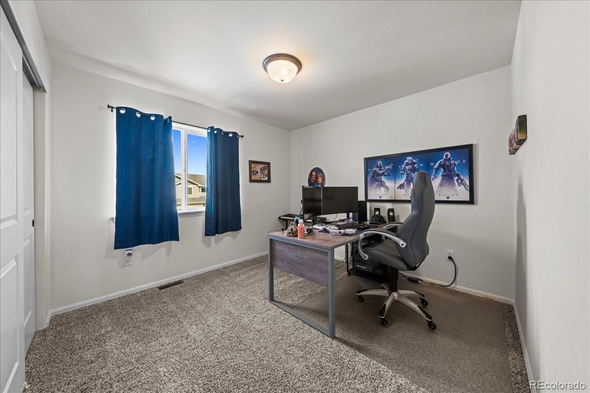 949 Ashbrook Drive Windsor, CO 80550 - Photo 18 of 33 a view of a workspace with furniture and a window