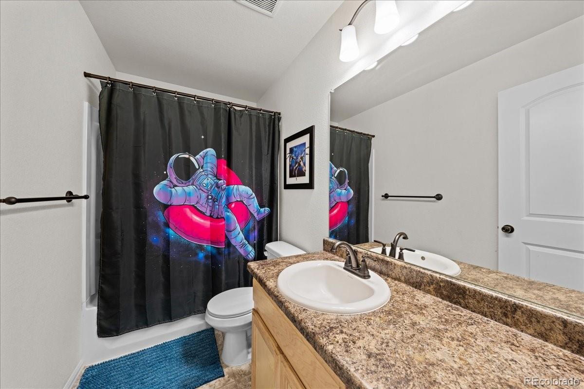 949 Ashbrook Drive Windsor, CO 80550 - Photo 20 of 33 a bathroom with a toilet sink vanity and mirror