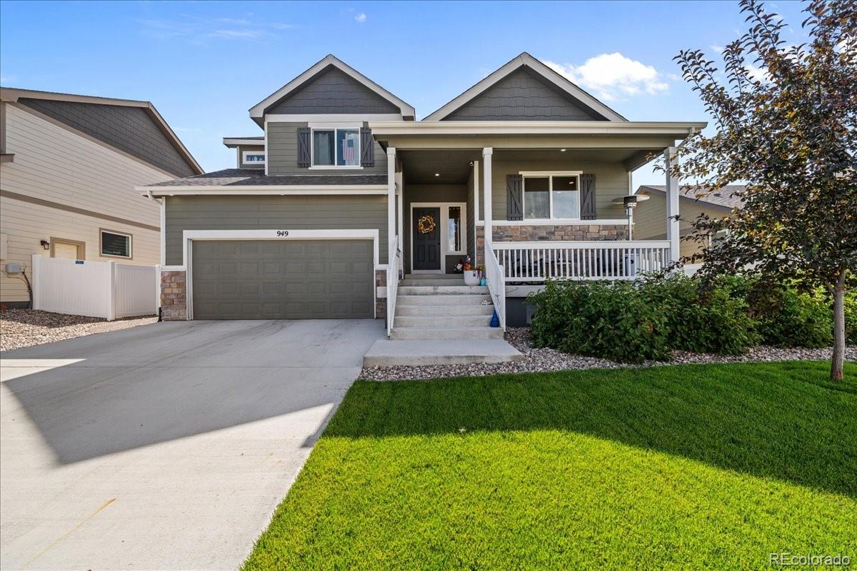 949 Ashbrook Drive Windsor, CO 80550 - Photo 2 of 33 a front view of a house with a yard and garage