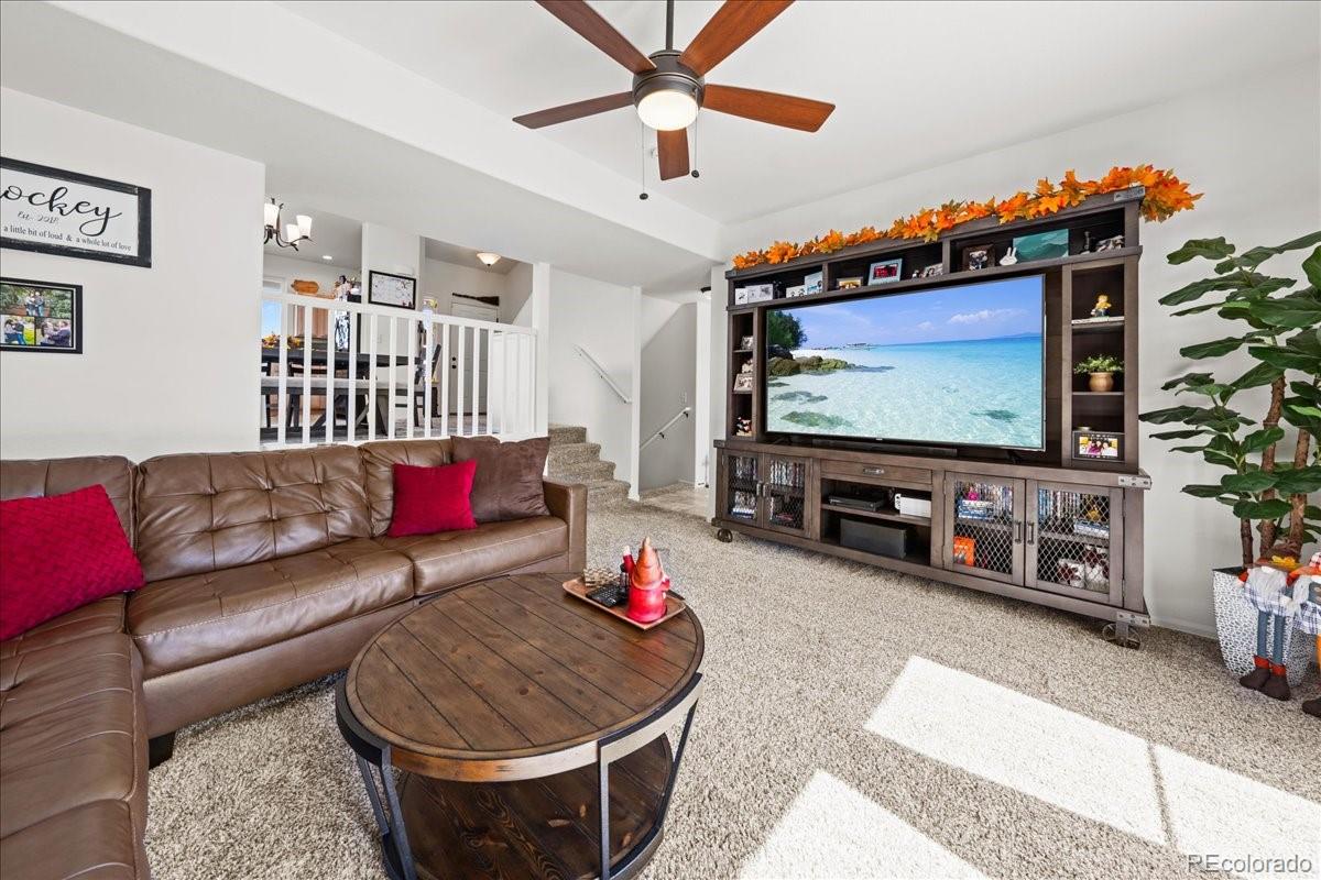 949 Ashbrook Drive Windsor, CO 80550 - Photo 5 of 33 a living room with furniture and a flat screen tv
