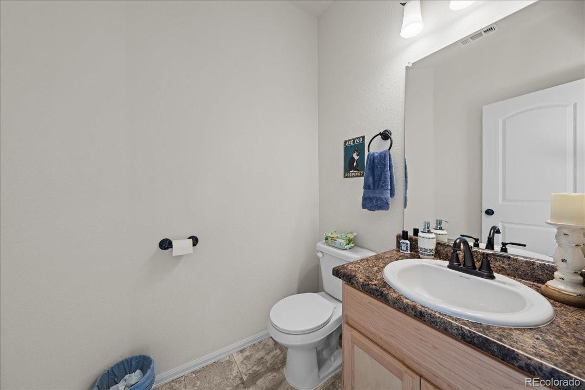 949 Ashbrook Drive Windsor, CO 80550 - Photo 6 of 33 a bathroom with a granite countertop toilet sink and mirror