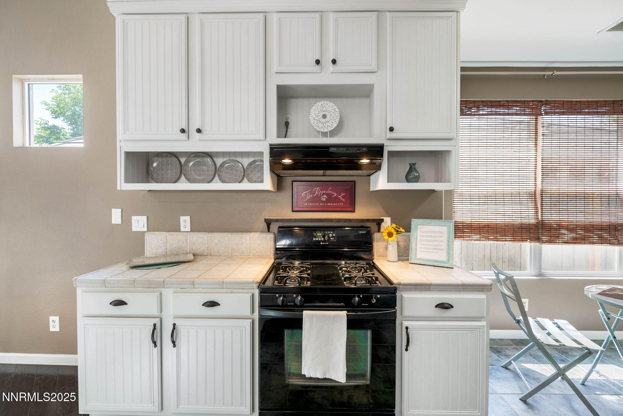 1295 Tule Drive Reno, NV 89521 - Photo 32 of 45 a kitchen with stainless steel appliances granite countertop a stove and a white cabinets