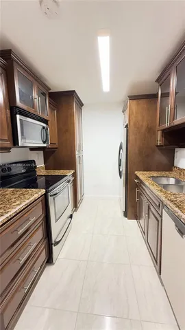 a kitchen with stainless steel appliances a refrigerator and a stove