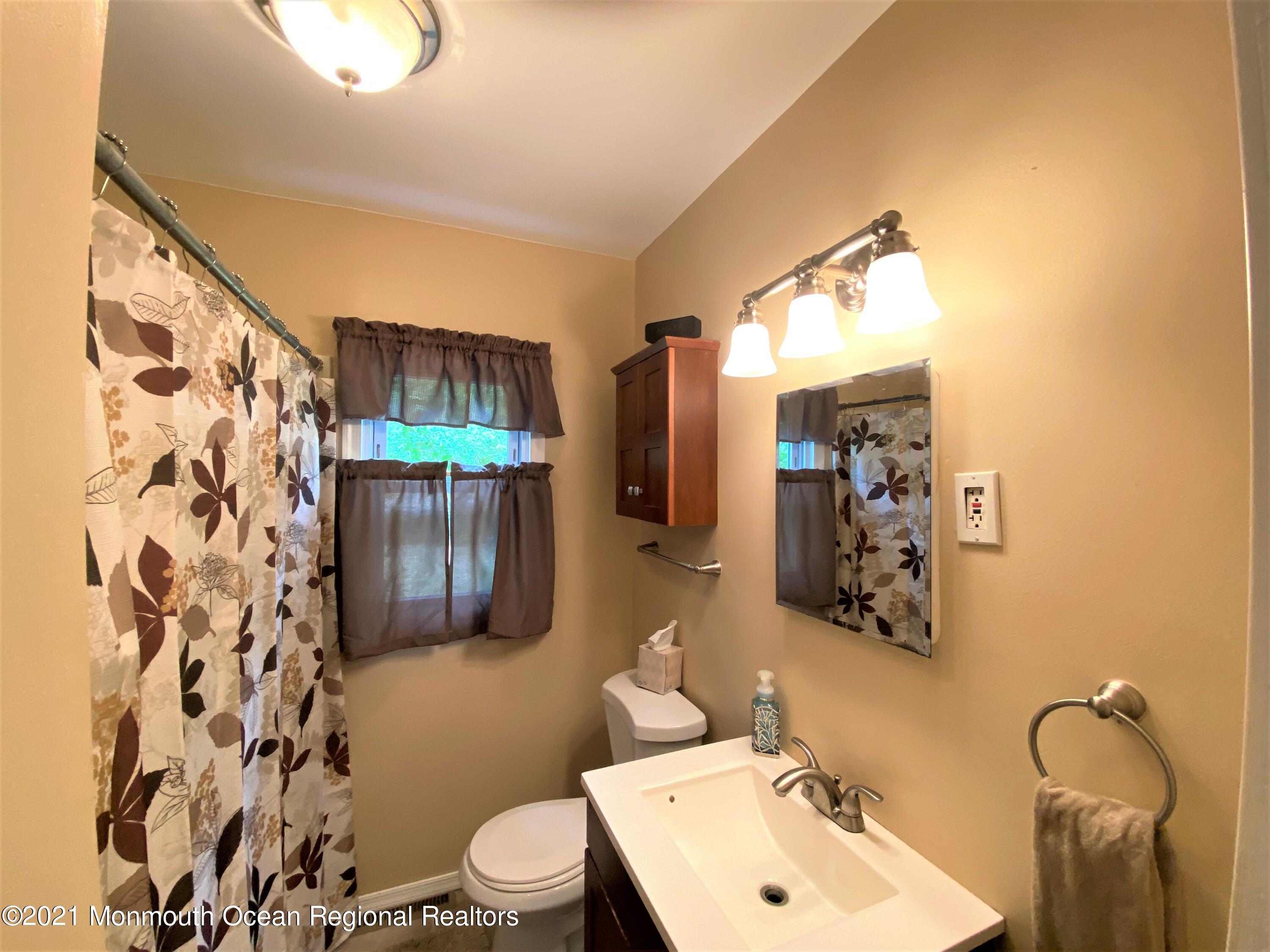 361 Black Oak Road Jackson, NJ 08527 - Photo 20 of 57 a bathroom with a sink mirror vanity and toilet