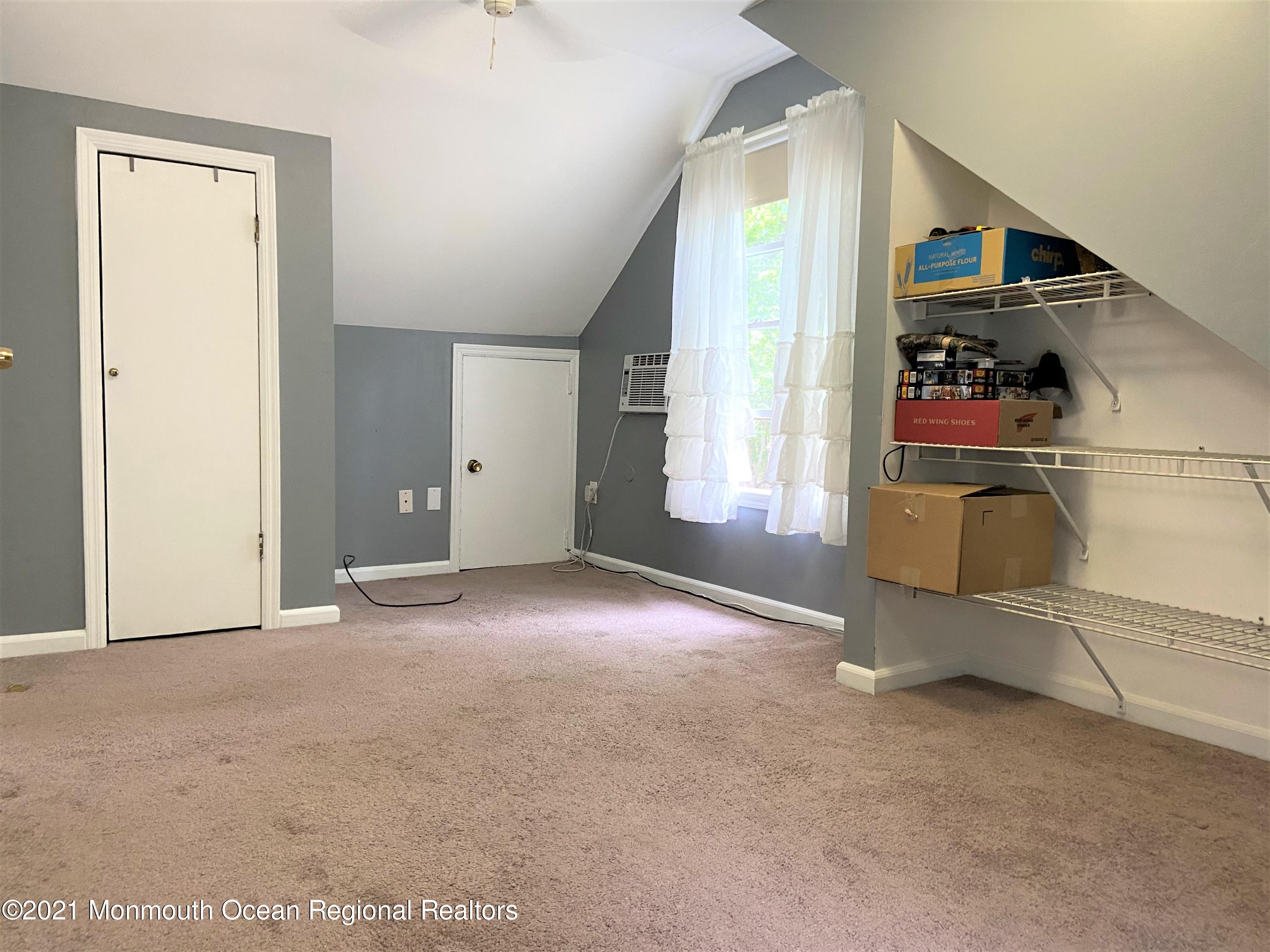 361 Black Oak Road Jackson, NJ 08527 - Photo 27 of 57 an empty room with windows and way to kitchen