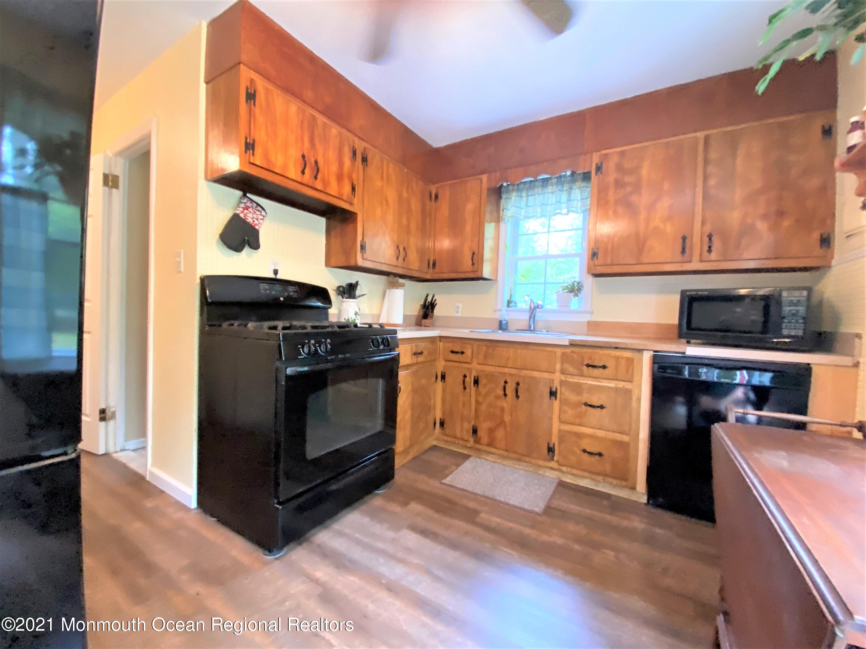 361 Black Oak Road Jackson, NJ 08527 - Photo 8 of 57 a kitchen with stainless steel appliances granite countertop a stove a sink and a refrigerator