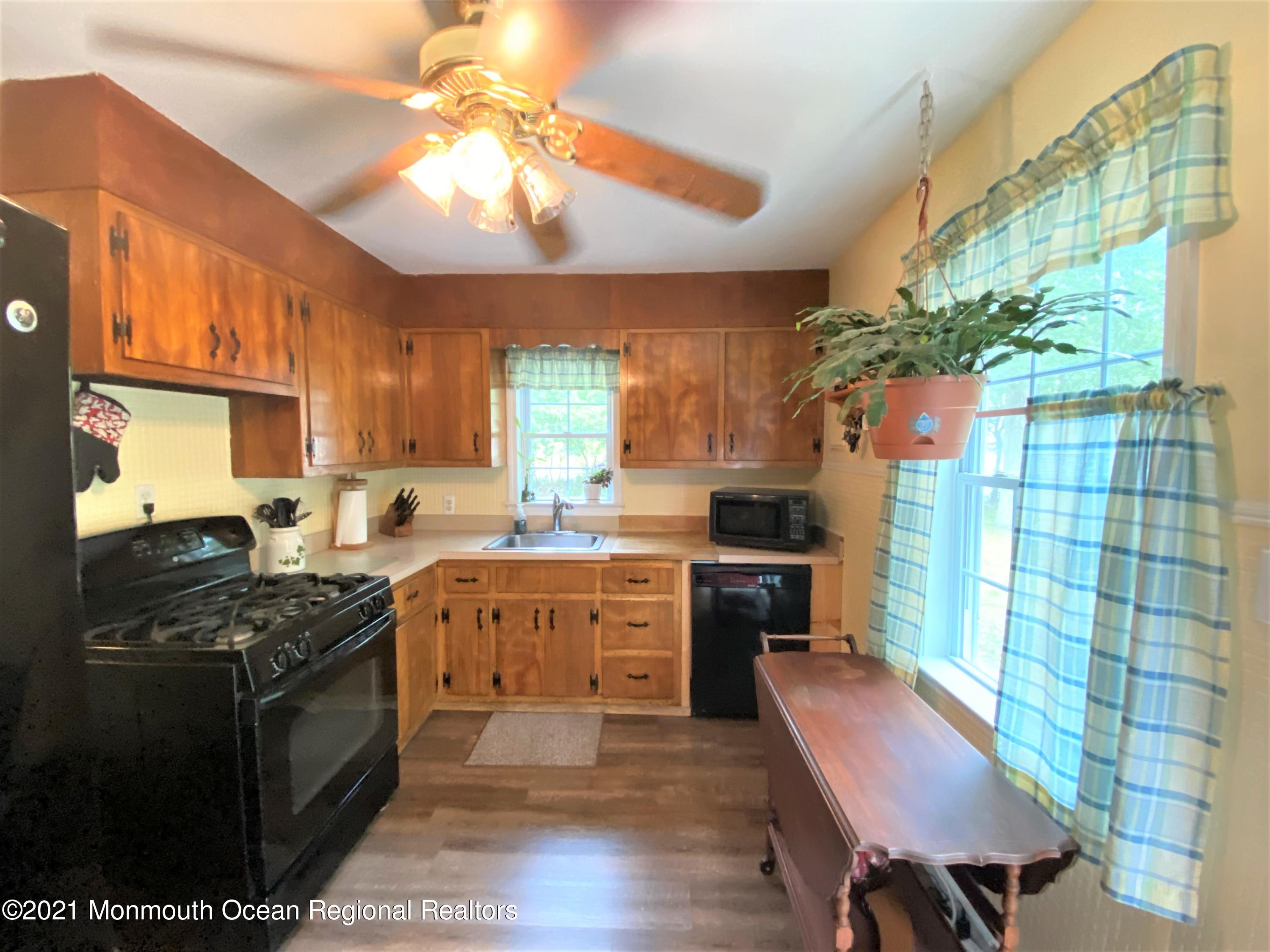 361 Black Oak Road Jackson, NJ 08527 - Photo 10 of 57 a kitchen with a stove cabinets and wooden floor