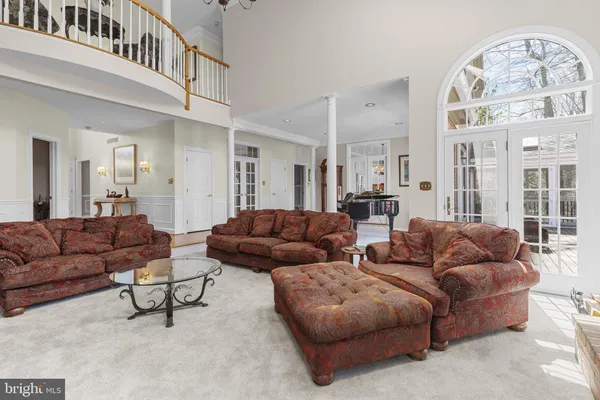 a kitchen with stainless steel appliances granite countertop a sink dishwasher a dining table and chairs with wooden floor