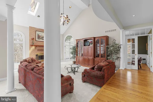 a living room with furniture a window and a flat screen tv