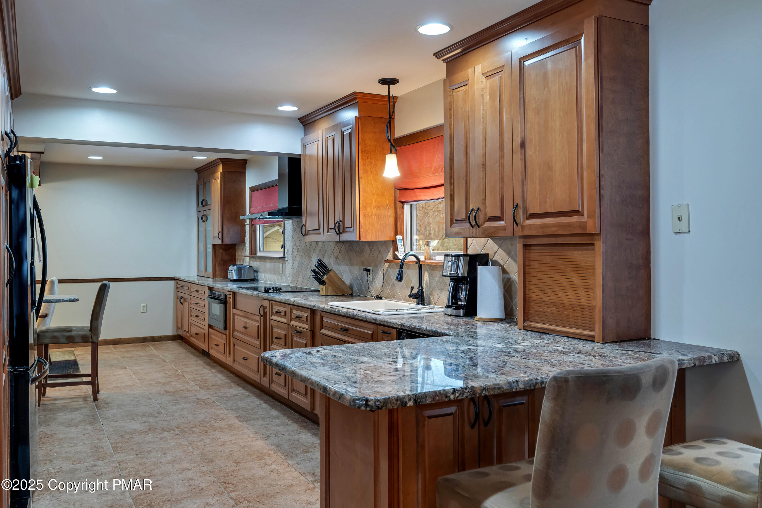 345 Canterbury Road Bushkill, PA 18324 - Photo 11 of 57 a kitchen with center island table and chairs