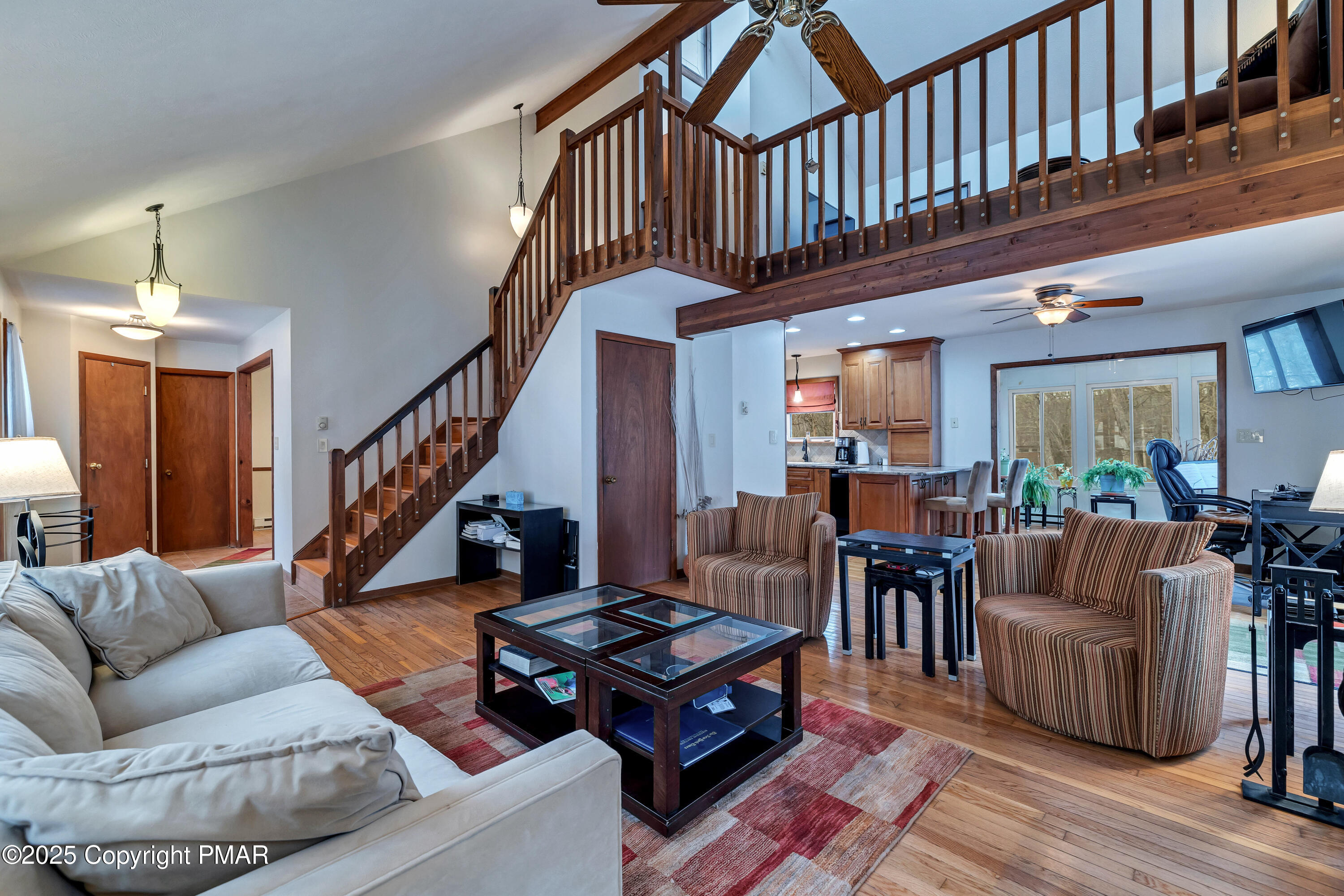 345 Canterbury Road Bushkill, PA 18324 - Photo 19 of 57 a living room with furniture stairs and a rug