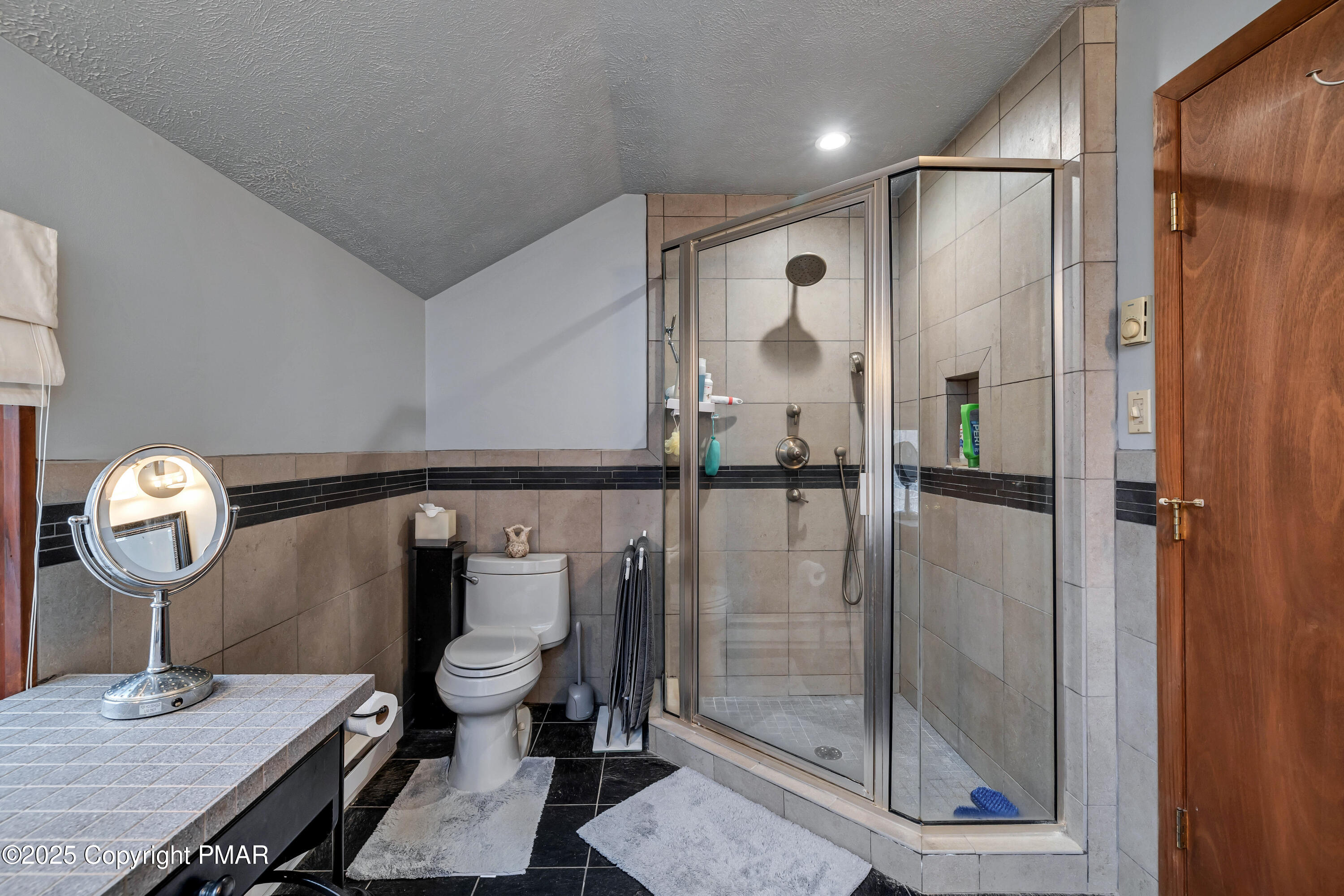 345 Canterbury Road Bushkill, PA 18324 - Photo 25 of 57 a bathroom with a mirror a toilet and a shower