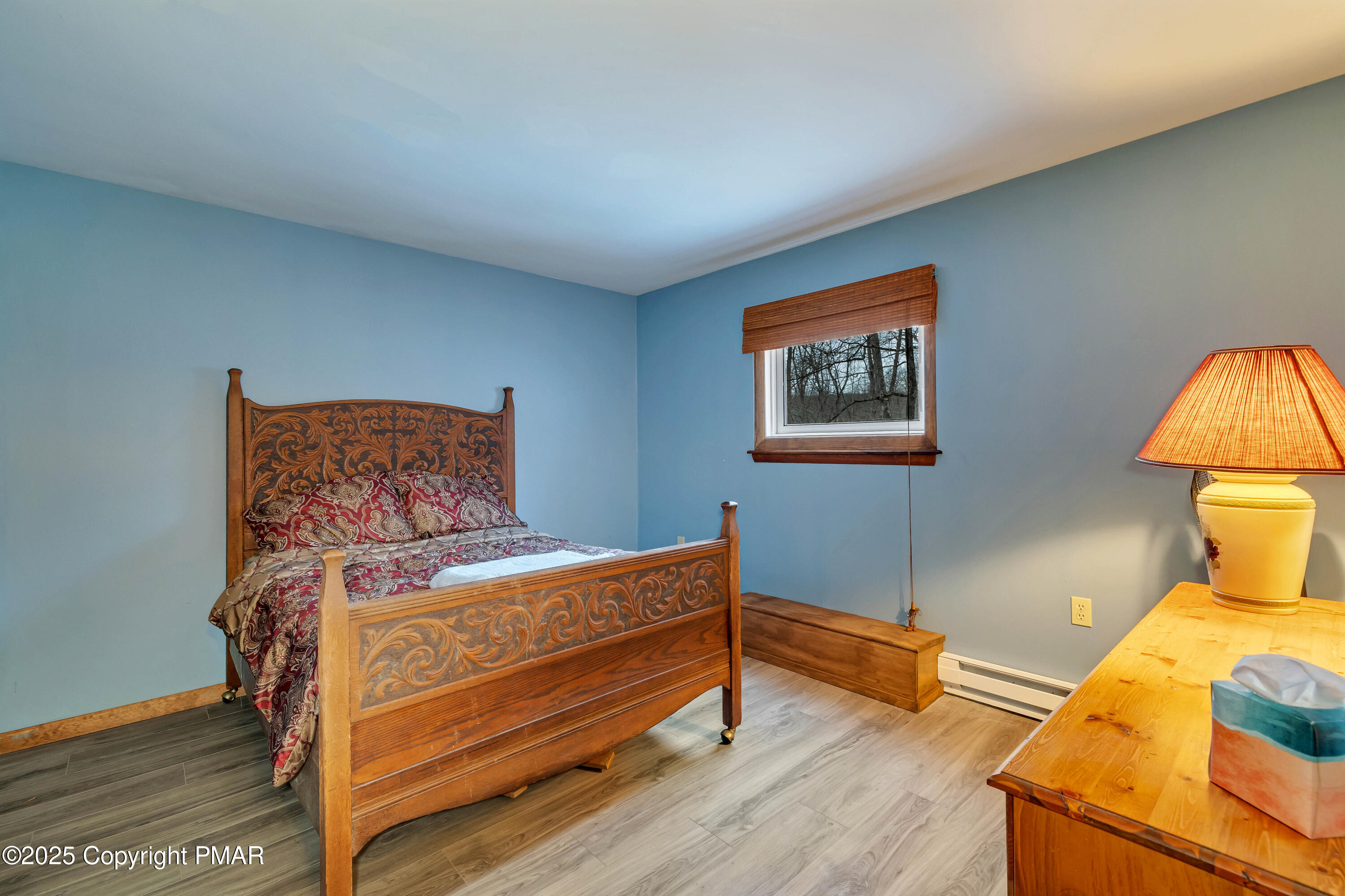 345 Canterbury Road Bushkill, PA 18324 - Photo 28 of 57 a bedroom with a bed and wooden floor