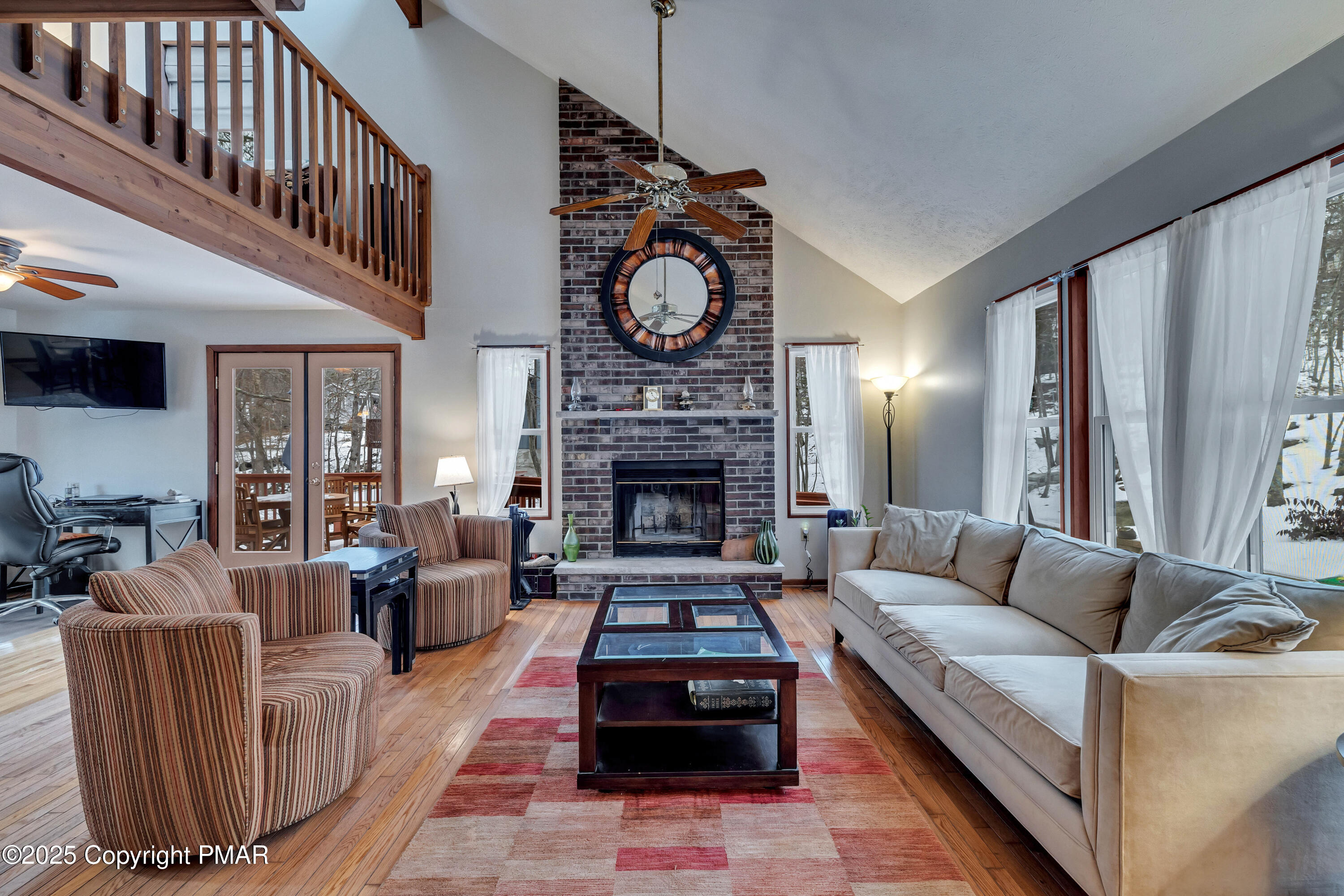 345 Canterbury Road Bushkill, PA 18324 - Photo 7 of 57 a living room with furniture a fireplace a rug and a window